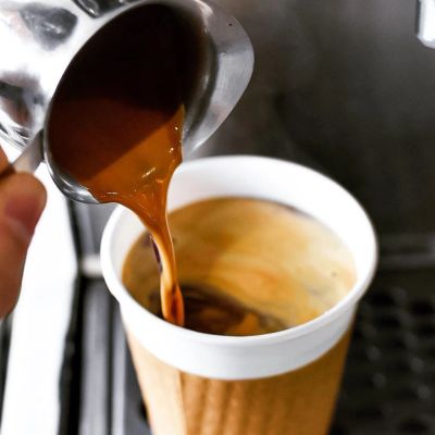 Pouring fresh, hot coffee into a coffee cup