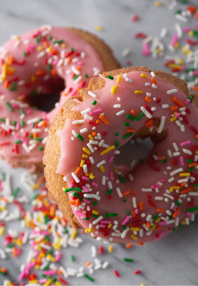 Two donuts with pink glaze and rainbow sprinkles