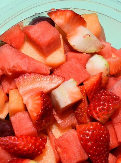 Bowl of assorted, sliced fruits