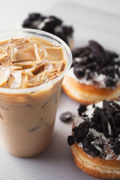 Iced coffee next to cookies and cream pastries