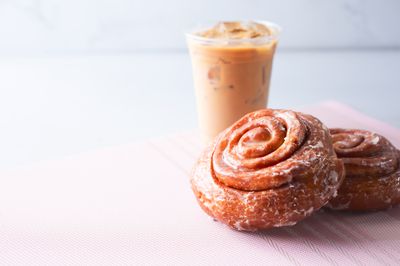 Two cinnamon rolls and an iced coffee